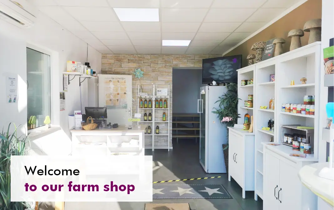 MycoVital_ A bright, modern farm shop interior with white shelves displaying jars, bottles, and plants. A sign in the foreground says, Welcome to our farm shop. The room has a tiled ceiling and a counter area.